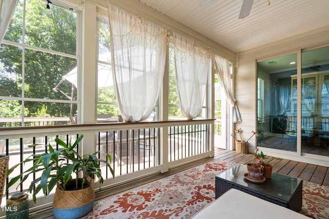 sunroom with wood-type flooring and a wooden deck