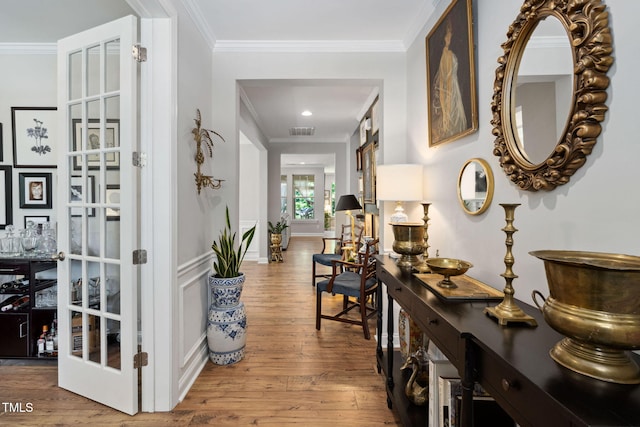 hallway with crown molding and wood finished floors
