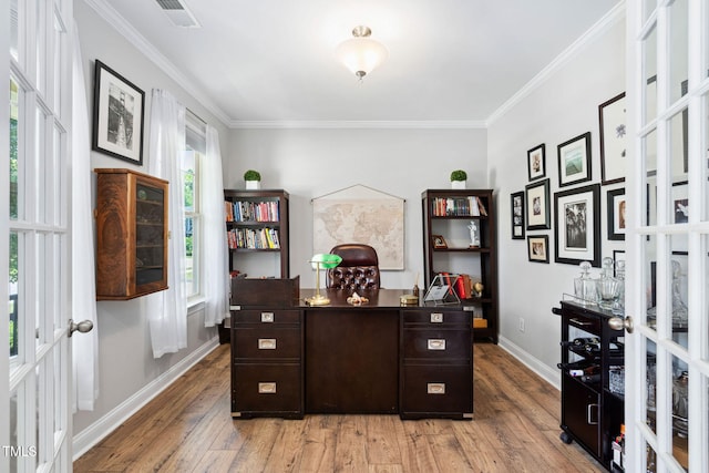 home office with light wood-style flooring, crown molding, french doors, and baseboards