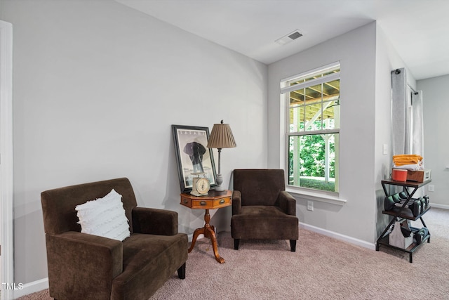 sitting room featuring carpet floors, plenty of natural light, and baseboards