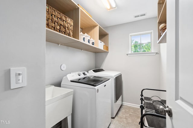 laundry room featuring washing machine and dryer and baseboards