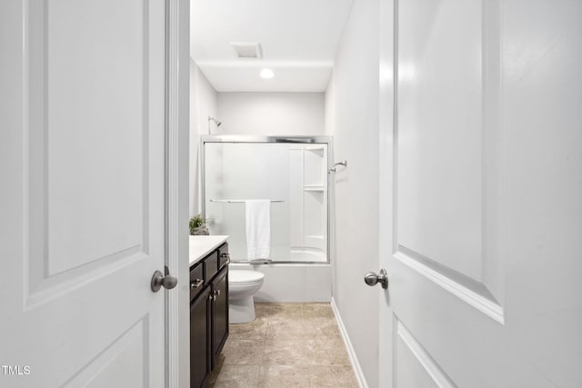 full bath featuring toilet, vanity, combined bath / shower with glass door, and baseboards