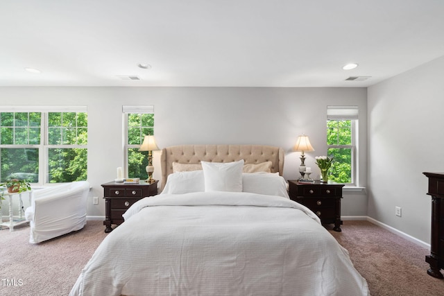 carpeted bedroom with multiple windows, baseboards, and recessed lighting