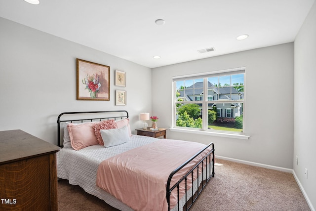 carpeted bedroom featuring baseboards and recessed lighting