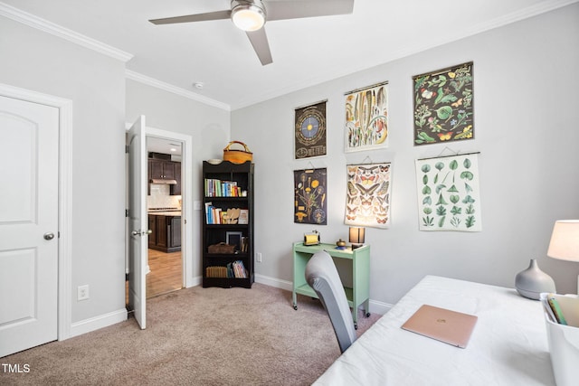 office area featuring a ceiling fan, carpet, crown molding, and baseboards