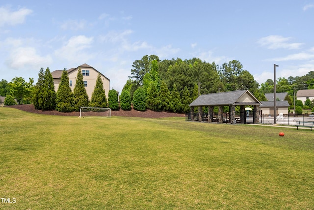 view of yard with a gazebo, a sport area, and fence