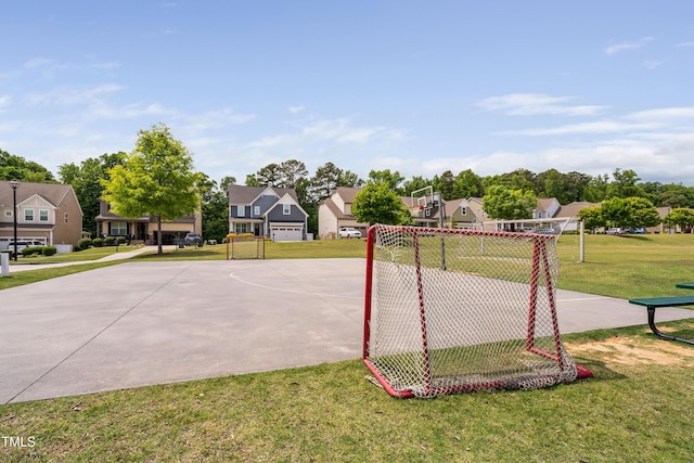 view of sport court with a residential view, community basketball court, and a lawn
