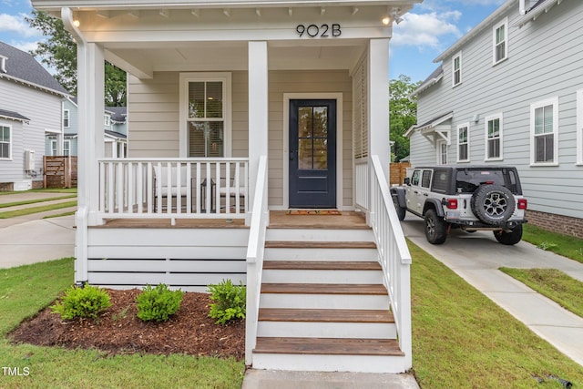 view of exterior entry featuring covered porch
