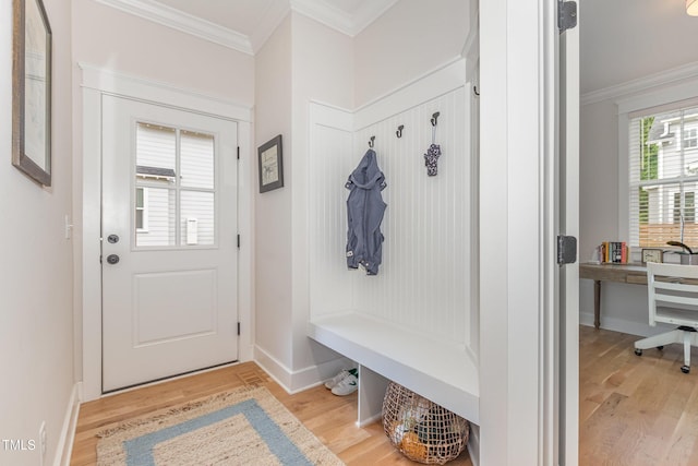 mudroom with light wood finished floors, ornamental molding, and baseboards