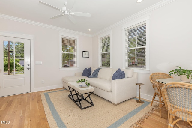 living room featuring baseboards, crown molding, light wood-type flooring, recessed lighting, and a ceiling fan