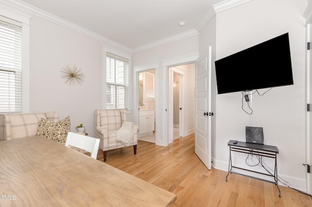 bedroom featuring light wood-style floors, ornamental molding, and baseboards