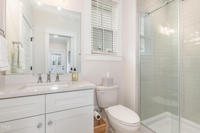 full bathroom featuring ornamental molding, a stall shower, toilet, and vanity