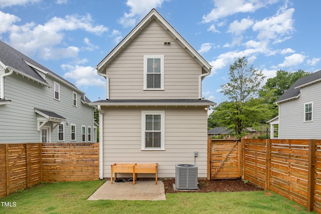 back of property with central AC, a patio area, and a gate