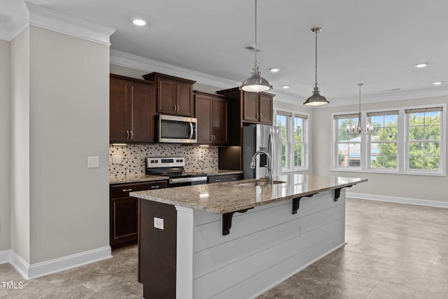 986 Gateway Commons Cir, Wake Forest, NC 27587 - kitchen featuring appliances with stainless steel finishes, a kitchen breakfast bar, decorative backsplash, baseboards, and crown molding