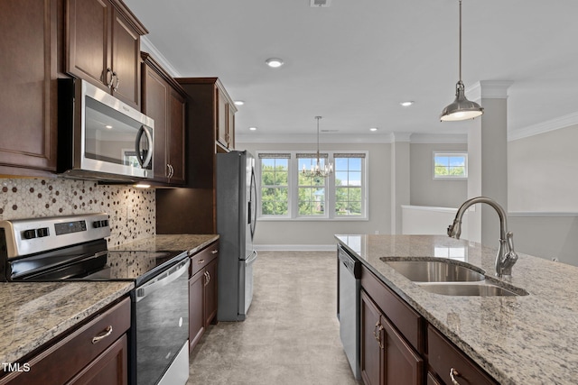 986 Gateway Commons Cir, Wake Forest, NC 27587 - kitchen with appliances with stainless steel finishes, a sink, healthy amount of natural light, ornamental molding, and pendant lighting