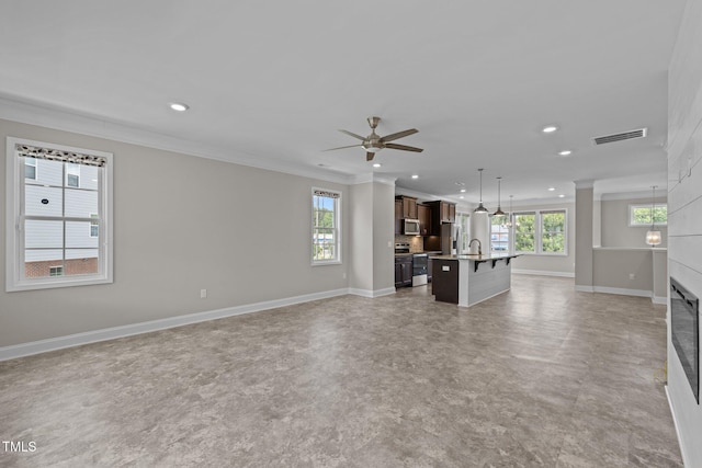 986 Gateway Commons Cir, Wake Forest, NC 27587 - unfurnished living room with recessed lighting, crown molding, baseboards, ceiling fan, and a large fireplace