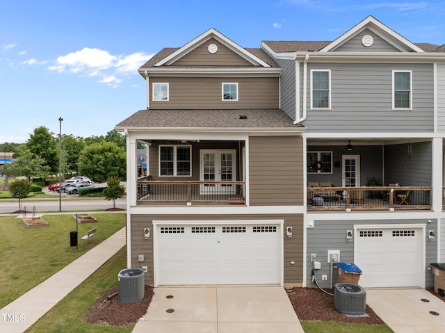 986 Gateway Commons Cir, Wake Forest, NC 27587 - multi unit property featuring an attached garage, concrete driveway, a front lawn, and a balcony