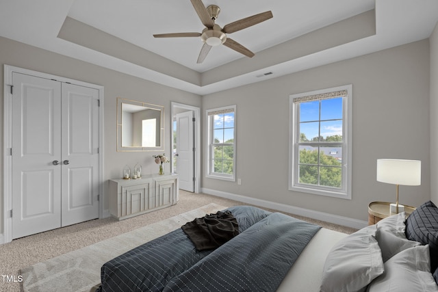 986 Gateway Commons Cir, Wake Forest, NC 27587 - bedroom featuring light carpet, a raised ceiling, baseboards, and ceiling fan