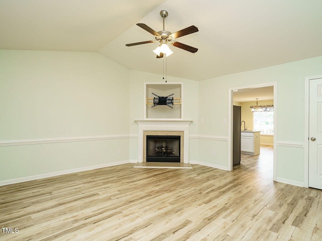 253 Middle Landing Dr, Smithfield, NC 27577 - unfurnished living room featuring ceiling fan, light wood-style flooring, a fireplace, vaulted ceiling, and baseboards