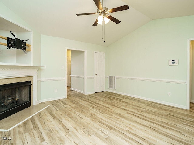 253 Middle Landing Dr, Smithfield, NC 27577 - unfurnished living room with lofted ceiling, a ceiling fan, wood finished floors, a high end fireplace, and baseboards