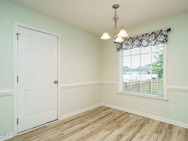 253 Middle Landing Dr, Smithfield, NC 27577 - spare room with light wood-type flooring, a chandelier, and baseboards