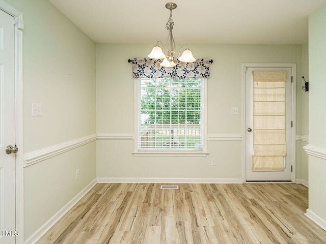 253 Middle Landing Dr, Smithfield, NC 27577 - unfurnished dining area featuring a chandelier, wood finished floors, and baseboards
