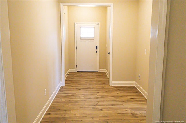 entryway with wood finished floors and baseboards