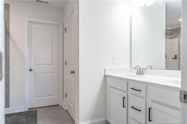 527 Weston Woods St, Raeford, NC 28376 - bathroom featuring baseboards, double vanity, and tile patterned floors