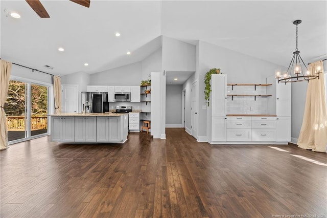 kitchen featuring open shelves, stainless steel appliances, dark wood-style flooring, a chandelier, and white cabinets