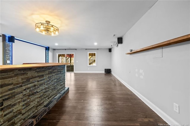 unfurnished living room with dark wood-style floors, baseboards, and recessed lighting