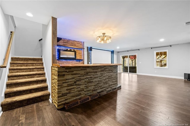 bar with stairway, dark wood finished floors, recessed lighting, baseboards, and a chandelier