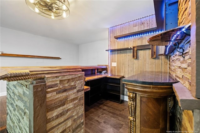 indoor dry bar featuring dark wood-style flooring
