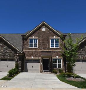 view of front of home with concrete driveway and brick siding