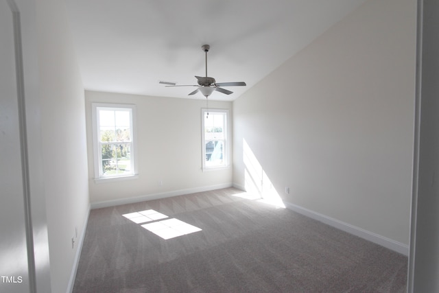 carpeted empty room featuring baseboards and ceiling fan