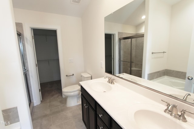 full bath with a shower stall, tile patterned floors, toilet, double vanity, and a garden tub
