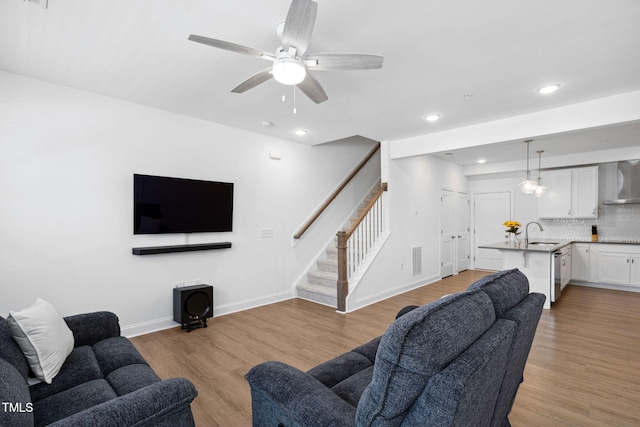 421 Wait Ave Unit 100, Wake Forest, NC 27587 - living room featuring stairway, a ceiling fan, recessed lighting, light wood-style floors, and baseboards