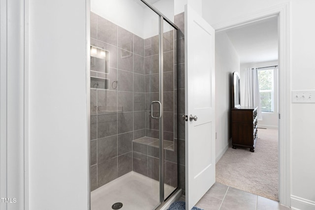 421 Wait Ave Unit 100, Wake Forest, NC 27587 - full bath featuring a stall shower, tile patterned flooring, and baseboards