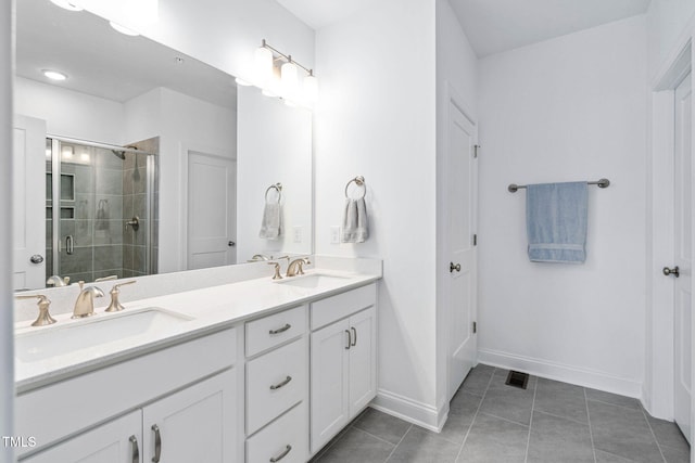 421 Wait Ave Unit 100, Wake Forest, NC 27587 - bathroom featuring a stall shower, tile patterned floors, double vanity, and baseboards