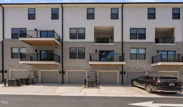 421 Wait Ave Unit 100, Wake Forest, NC 27587 - view of property featuring an attached garage, driveway, and central AC unit