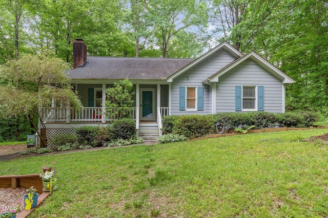 single story home featuring a chimney, covered porch, and a front lawn