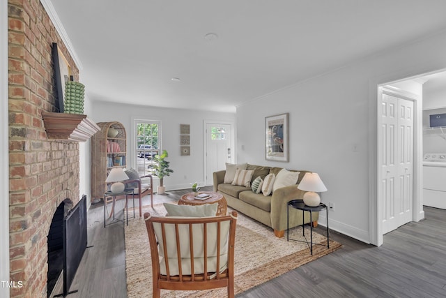 608 Cross Timbers Dr, Durham, NC 27713 - living room with a brick fireplace, washer / clothes dryer, wood finished floors, and baseboards