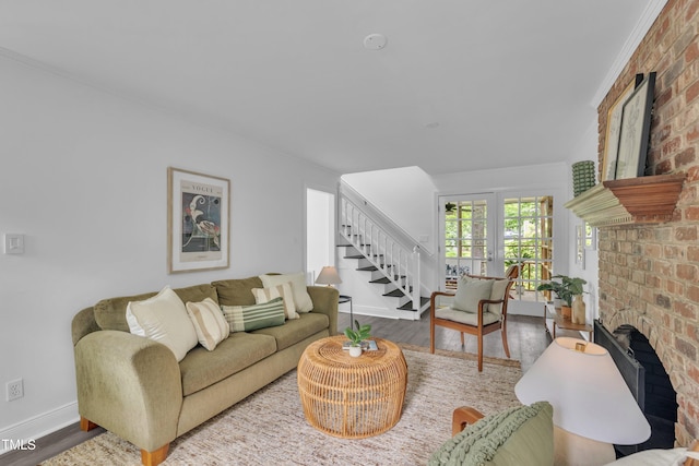 608 Cross Timbers Dr, Durham, NC 27713 - living area with stairway, baseboards, wood finished floors, and a brick fireplace