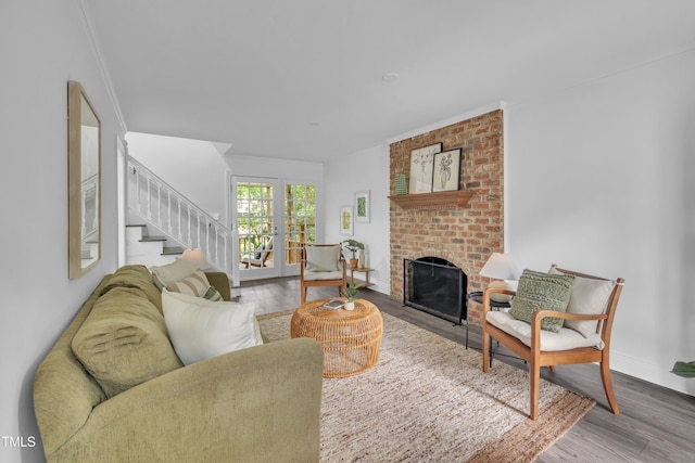 608 Cross Timbers Dr, Durham, NC 27713 - living room featuring wood finished floors, stairs, a fireplace, ornamental molding, and baseboards