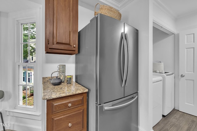 608 Cross Timbers Dr, Durham, NC 27713 - kitchen featuring freestanding refrigerator, wood finished floors, ornamental molding, light stone counters, and brown cabinetry