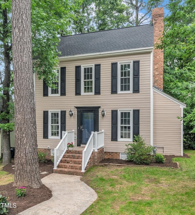 608 Cross Timbers Dr, Durham, NC 27713 - colonial-style house with a chimney, a front yard, a shingled roof, and crawl space