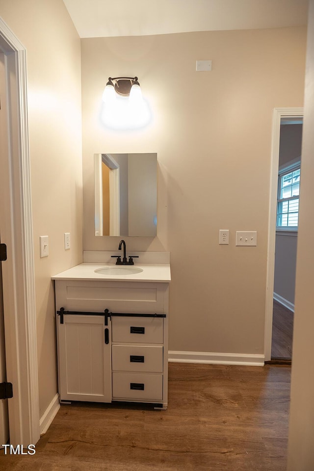 6 First St, Franklinton, NC 27525 - bathroom featuring baseboards, vanity, and wood finished floors