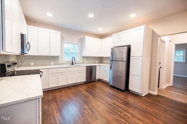 6 First St, Franklinton, NC 27525 - kitchen with appliances with stainless steel finishes, healthy amount of natural light, light stone counters, tasteful backsplash, and recessed lighting