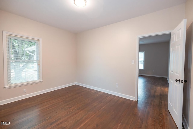 6 First St, Franklinton, NC 27525 - empty room with plenty of natural light, dark wood-type flooring, and baseboards