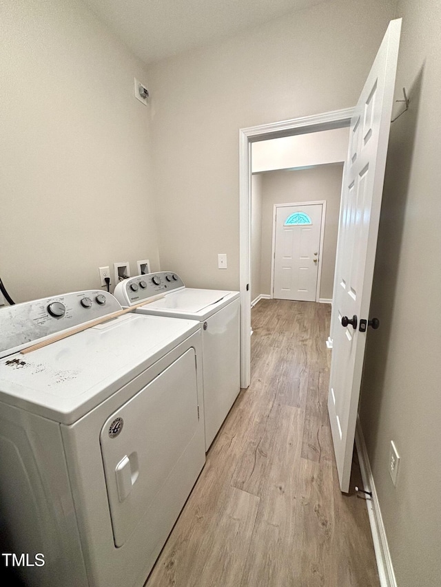 6 First St, Franklinton, NC 27525 - washroom with washing machine and dryer, light wood-type flooring, and baseboards