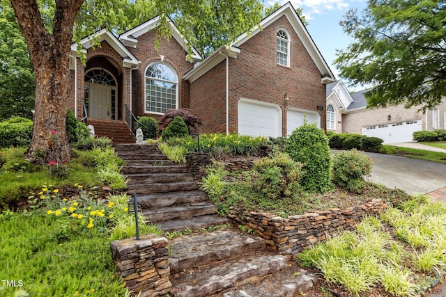 1224 Wedgeland Dr, Raleigh, NC 27615 - traditional home featuring brick siding, a garage, and driveway